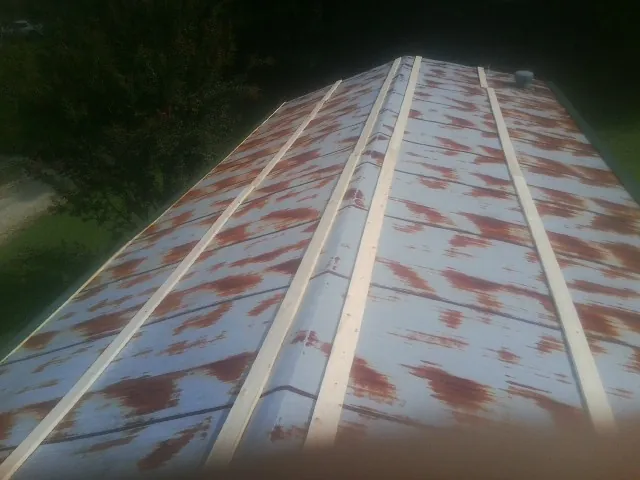 Rusted metal roof panels with new wood purlins before replacement — Storm Damage Roof Repair in Chillicothe by Roofing Brothers